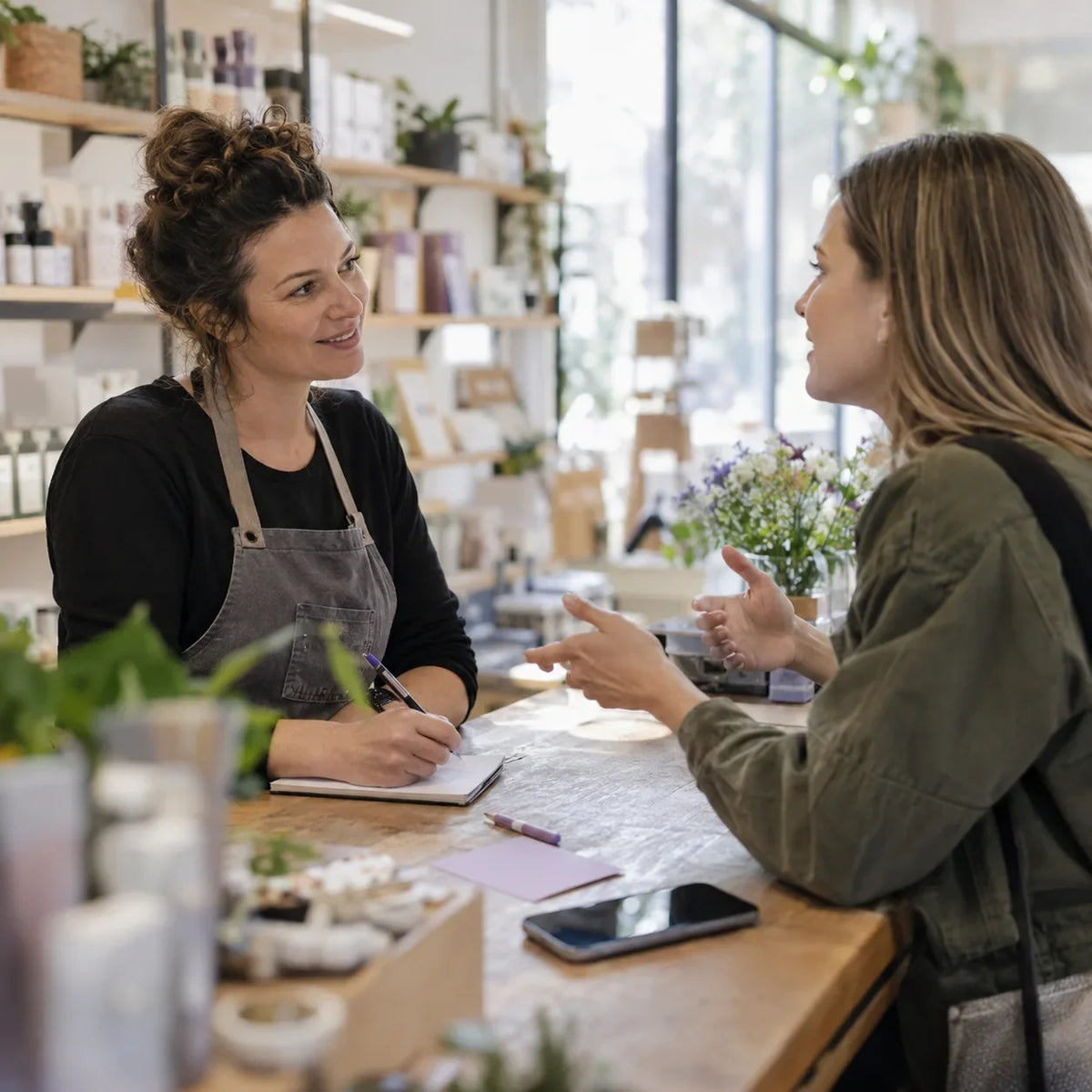 A shop owner asks a customer about how they find local businesses online.